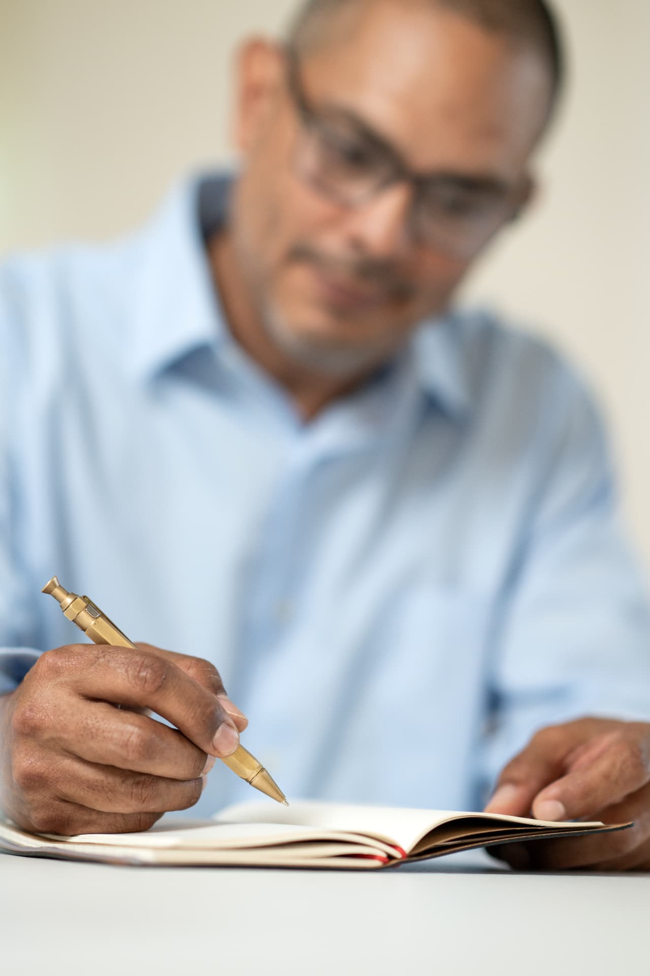 Carlos writing notes at a desk